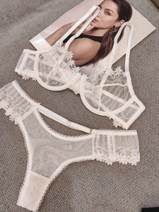 Detail view of cream white daisy lace lingerie set with underwire bra and metal buckles