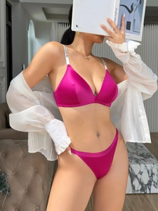 Detail view of fuchsia satin lingerie set with letter-printed straps and lace finish