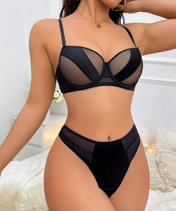 Detail view of black mesh patchwork bra and high waist panty set with sheer panels