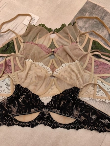 Dettaglio di reggiseni in pizzo con ricami raffinati e texture a rete in vari colori