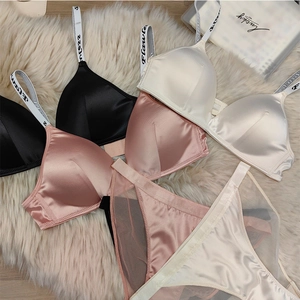 Satin lingerie set detail with Flawless letter straps and breathable mesh panels