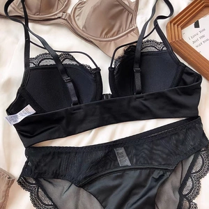 Detail of black lace lingerie set with satin cups, 75B size label and fabric composition
