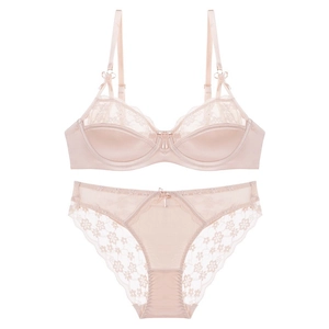 Detailed view of champagne satin bra and lace panties set with delicate floral embroidery