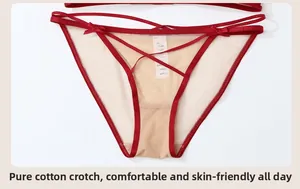 Détails de culotte sexy en dentelle rouge avec nœuds papillon et gousset en coton doux