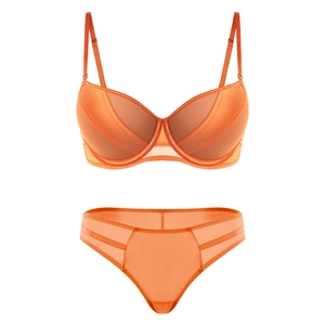 Detailed view of orange lingerie set featuring mesh patchwork and push-up underwire bra