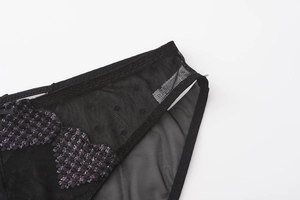 Detailed close-up of black mesh lingerie featuring purple embroidered hearts and lace