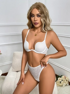 Detail of white mesh lace bra and leopard print panties on a minimalist background