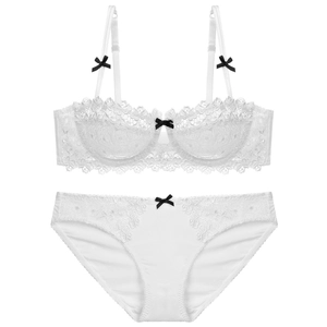 Elegant white floral lace lingerie set with contrasting black bows and scalloped edges