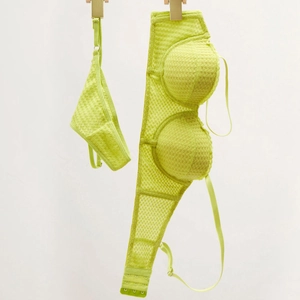 Detail of neon green honeycomb mesh fabric on a push-up bra and panty lingerie set