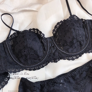 Close-up of black lace lingerie set with eyelash trim and intricate floral patterns