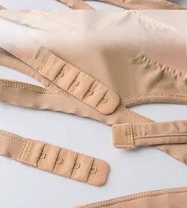 Detail of multi-row hook closure on seamless skin-colored triangle cup bra
