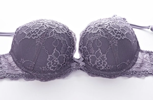 Detailed view of elegant purple lace bra with push-up padding and delicate bow accent