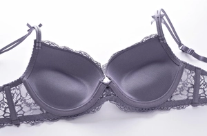Close-up detail of grey-purple lace bra showing eyelash lace trim and bow accent