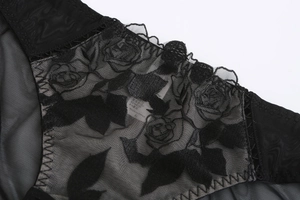Detail shot of black lace bra with rose embroidery and intricate zigzag stitching texture