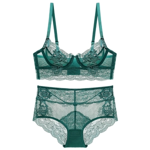 Close-up of emerald green lace lingerie set with floral embroidery and mesh details