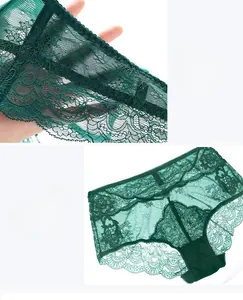 Detail of dark green sheer lace panties featuring delicate floral mesh and side straps