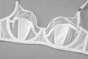 Detail view of white sheer mesh balconette bra with underwire and elegant silver ring accents