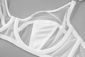 Detailed close-up of white mesh lace lingerie with satin trim and silver hardware