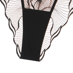 Detail of black lace embroidery and breathable mesh fabric on women's lingerie