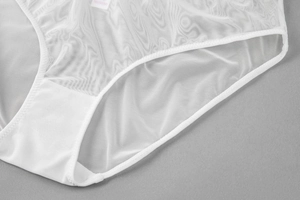 Detail of white mesh panty with wave texture and reinforced cotton crotch lining