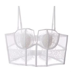Detailed close-up of white eyelash lace bustier with floral mesh and corset boning