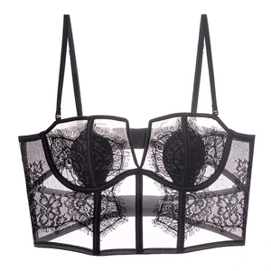 Detail of black floral lace bustier with eyelash trim and sheer mesh embroidery
