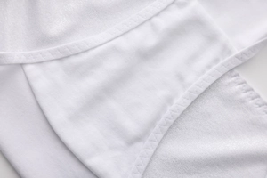Detailed macro view of white cotton lining and high-quality zigzag stitching on panties