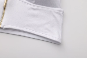 Detail of white triangle bra showing golden zipper and professional stitching craftsmanship