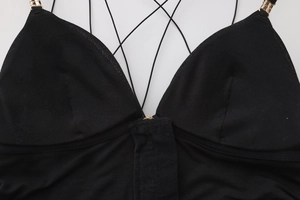 Detail of black V-neck lingerie with gold hardware and thin adjustable straps