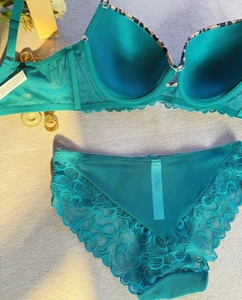 Flat lay of cyan lace lingerie set with leopard trim bra and matching panties