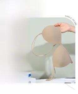 Detail view of seamless beige push-up bra with front closure and smooth fabric texture