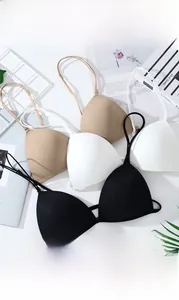 Detailed flat lay of four seamless front-closure push-up bras in diverse skin tones and black