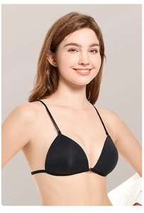 Close-up of black seamless triangle bra with thin straps on model in grey background