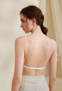 Detail of white backless lace bra with adjustable straps and u-shaped open back