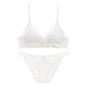 Detail of white lace lingerie set with floral embroidery and delicate silk accents