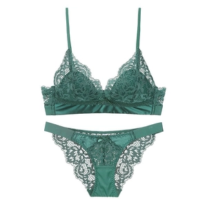 Flat lay of dark green lace lingerie set with wireless triangle bra and satin panties