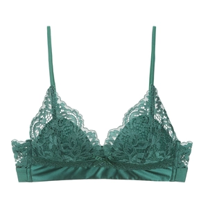 Detailed macro view of green floral lace triangle cup and satin bow on the wireless bra