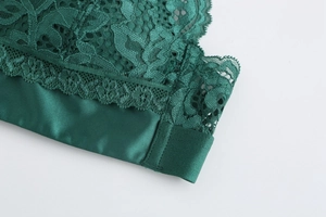 Detail of dark green floral lace and satin fabric on a French style wireless bralette