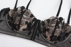 Close-up of black lace bra featuring 3D rose embroidery and sheer mesh detail