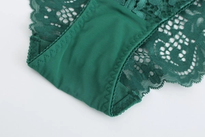 Detail of dark green lace panties showing intricate floral patterns and smooth inner lining