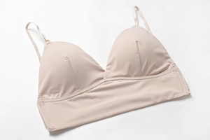 Macro detail of beige seamless triangle bralette featuring wide underband and thin straps