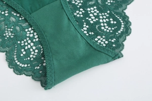 Detail of dark green lace and silk fabric with fine stitching on women lingerie