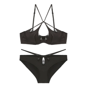 Detailed view of black satin lingerie set with eyelash lace trim and cross-strap design