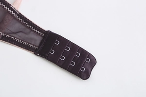 Detailed macro view of deep coffee mesh bra featuring a secure three-row hook and eye back closure