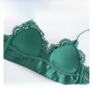 Detailed close-up showing soft cotton lining and delicate lace edge on dark green bra