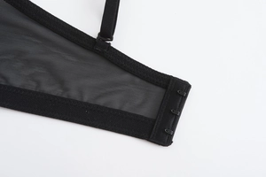 Close-up of black lace bra back closure with three-row hooks and adjustable straps