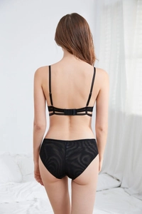 Detailed back view of black lace bra set with strappy design and sheer mesh fabric