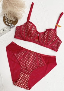 Flat lay of thin wine red lace lingerie set with gold rings and 75B size detail