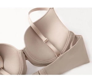 Detailed close-up of seamless nude bra cups and adjustable strap connection point