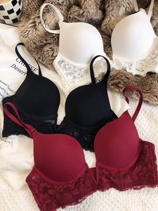 Flat lay of lace lingerie set in white, black and burgundy with smooth cups and floral trim